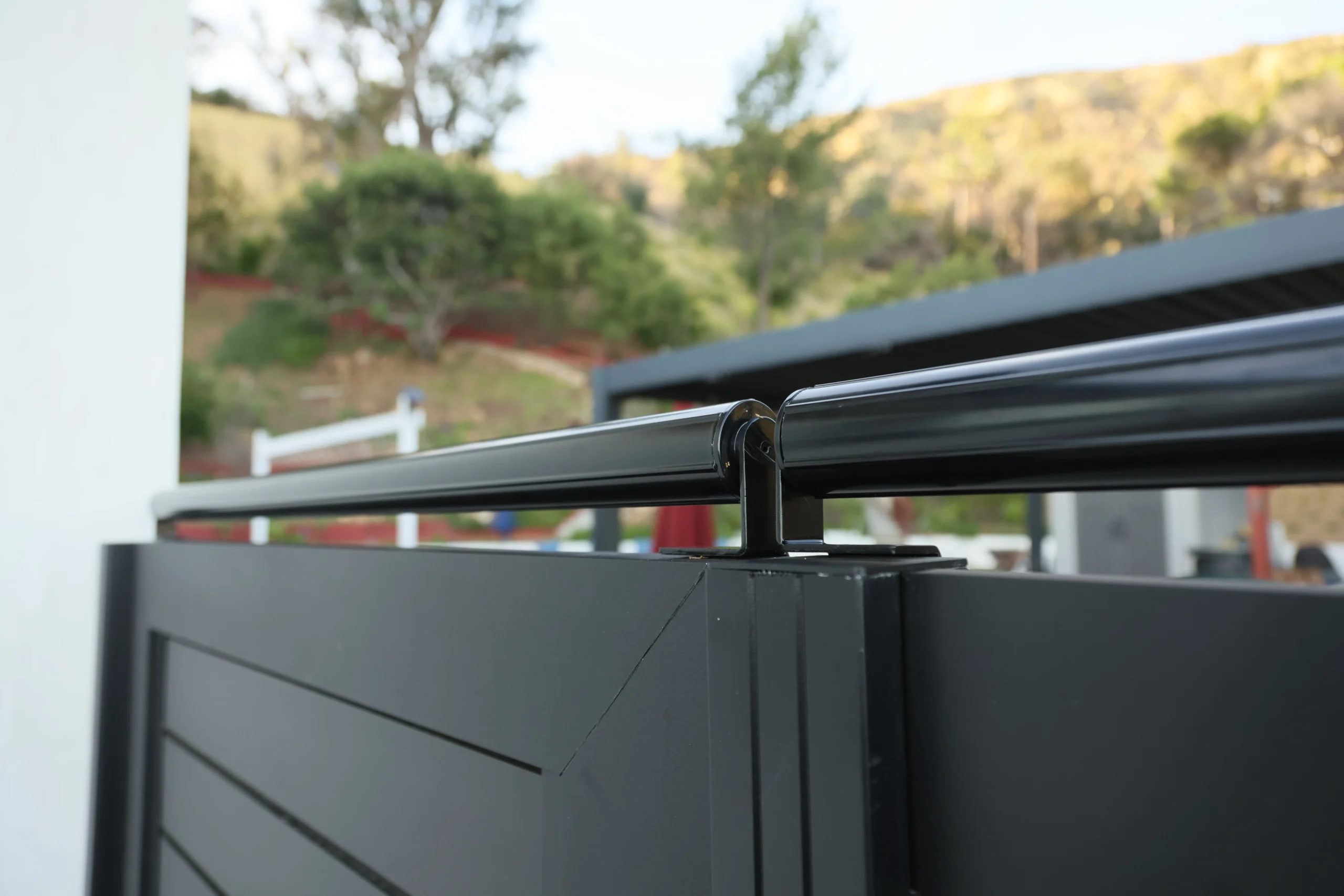 Close-up coyote roller bracket on aluminum gate