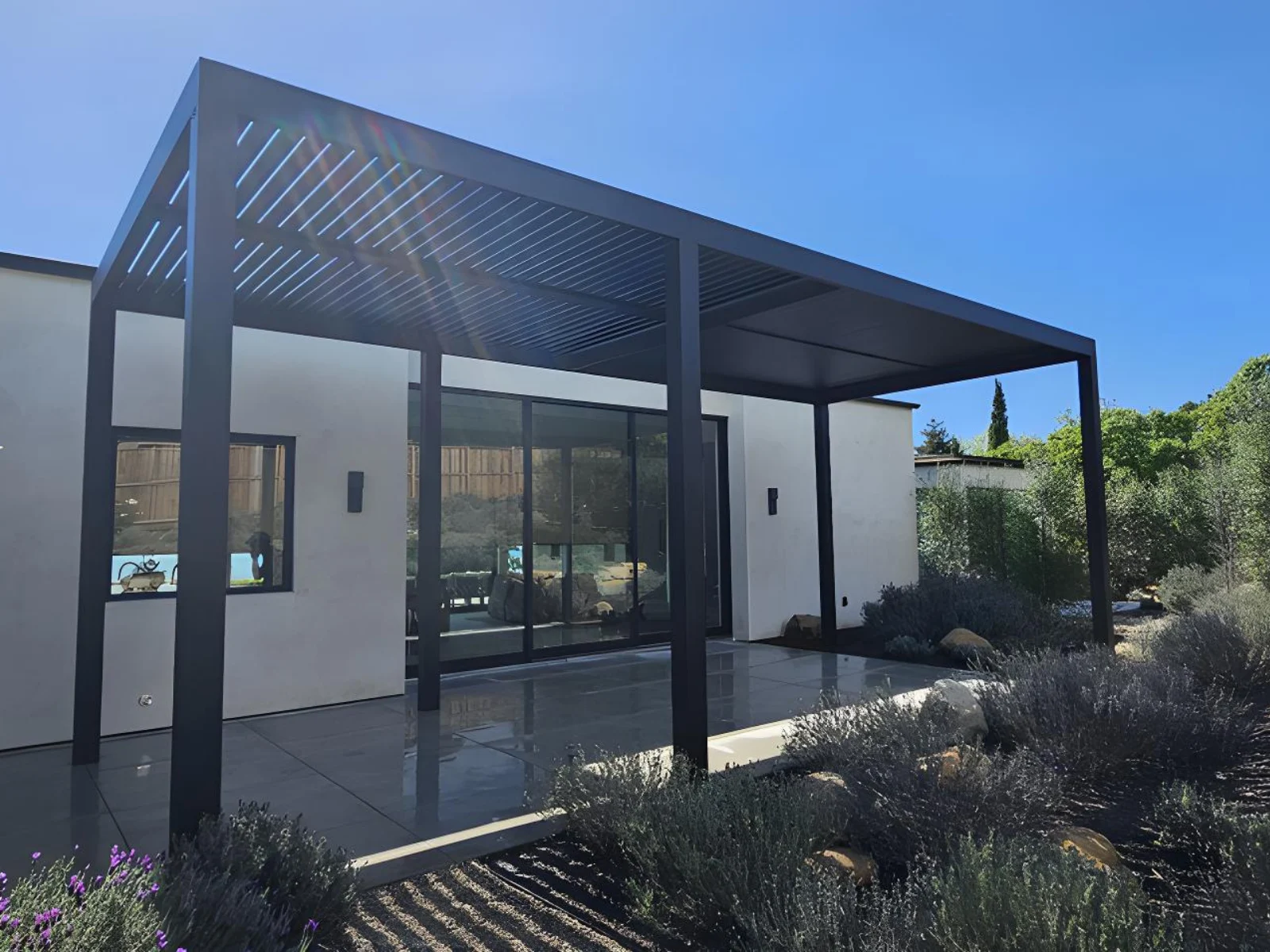 Installed aluminum slat roof pergola shading a residential patio