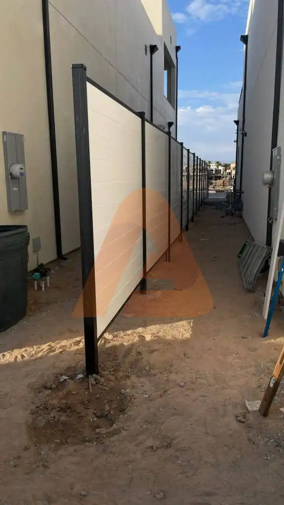 Modern horizontal wood fence enclosing a backyard garden with wooden posts and horizontal slats.